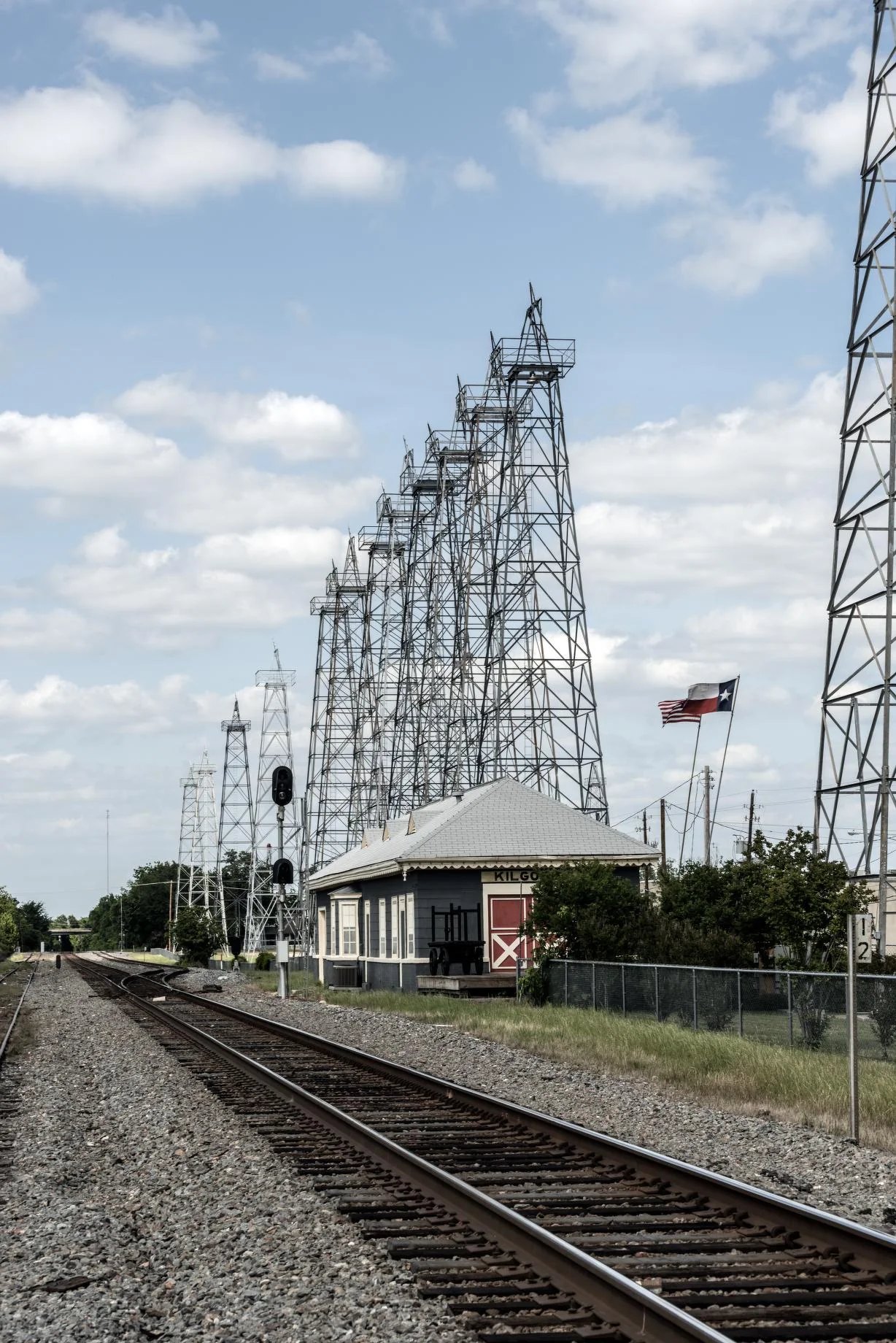 Oil derrick structures, railway tracks, and a depot in downtown Kilgore, Texas