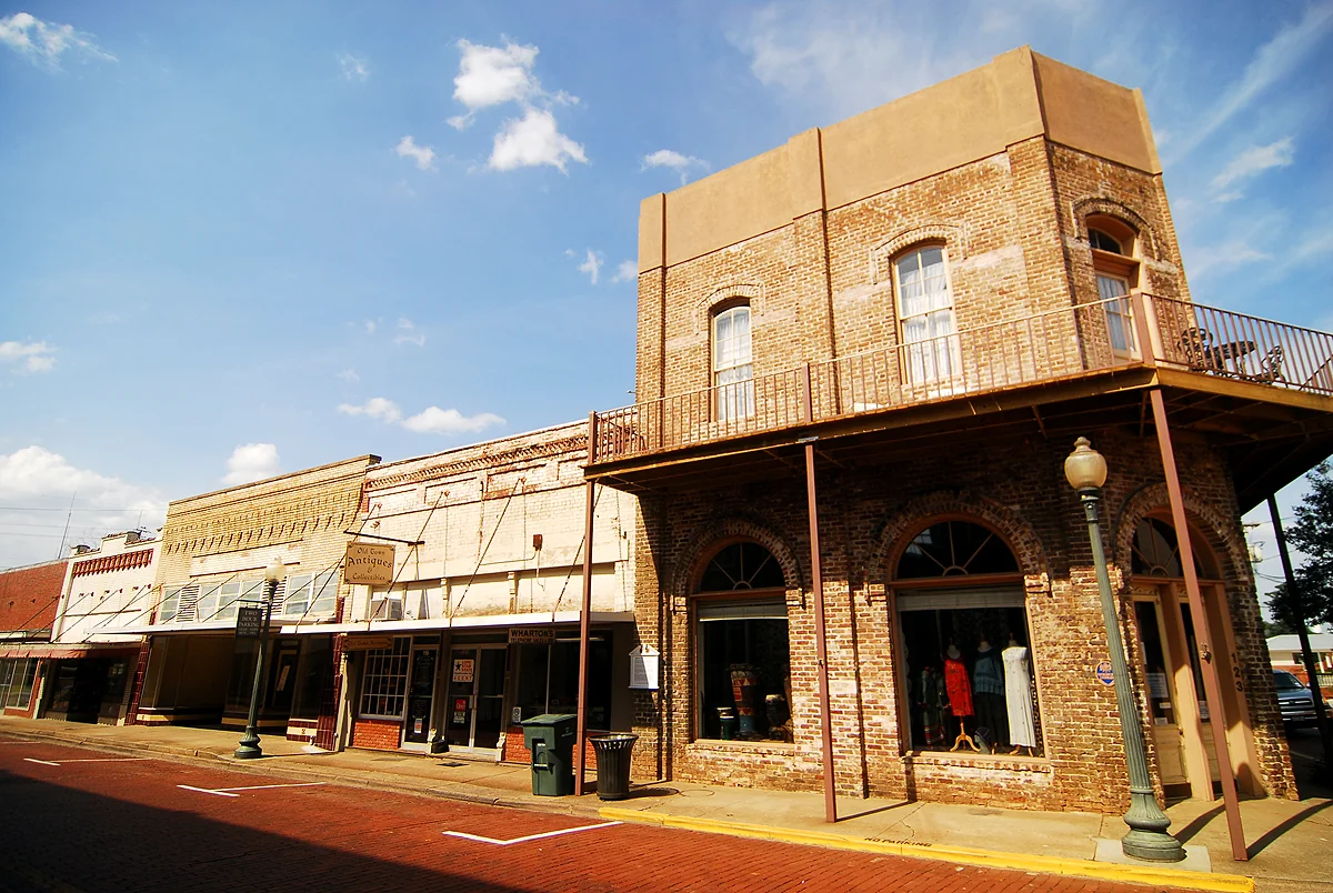 Historic brick storefronts and a corner building in downtown Nacogdoches, Texas