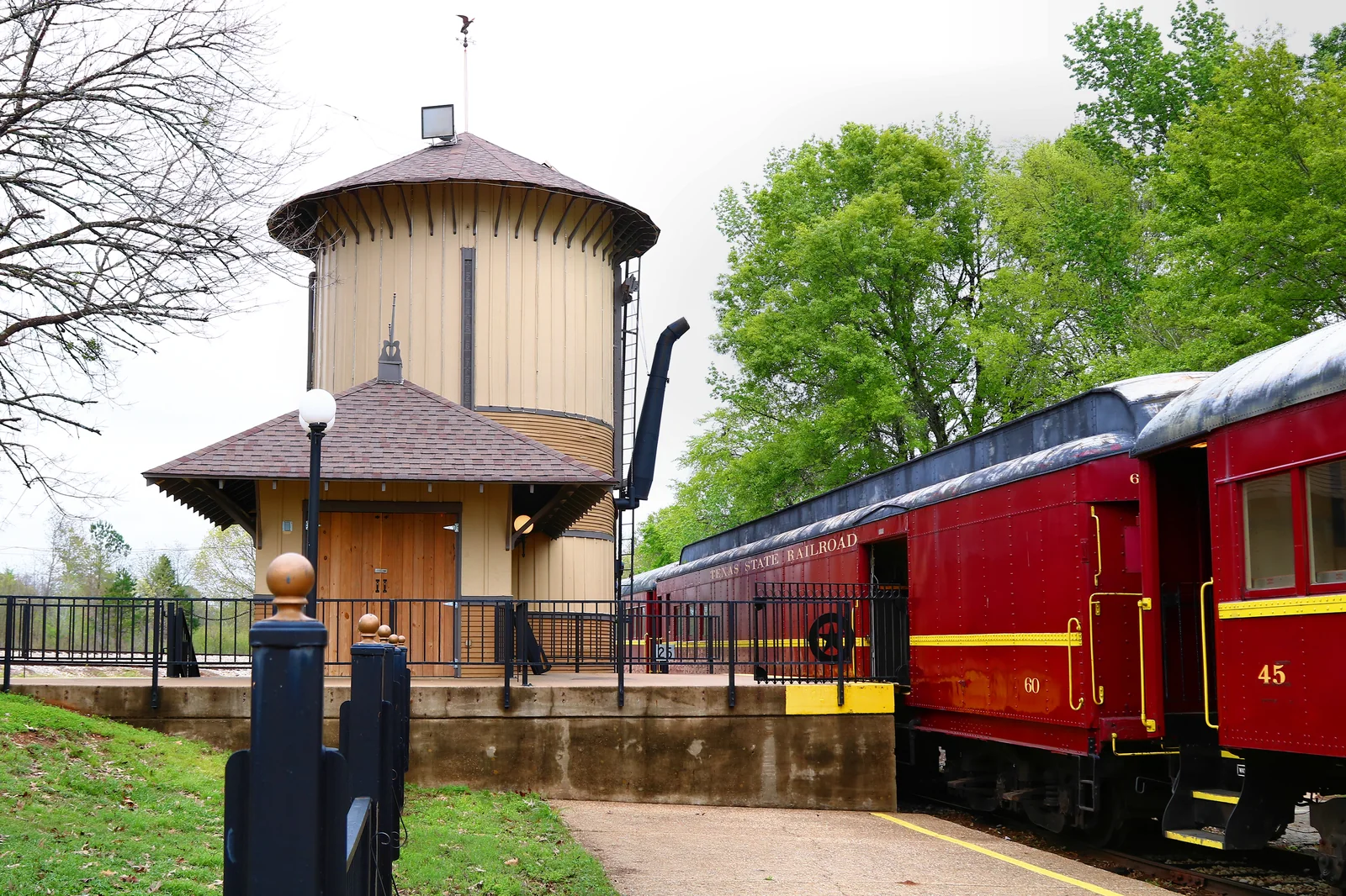 Texas State Railroad platform, water tower and passenger cars near Palestine, Texas